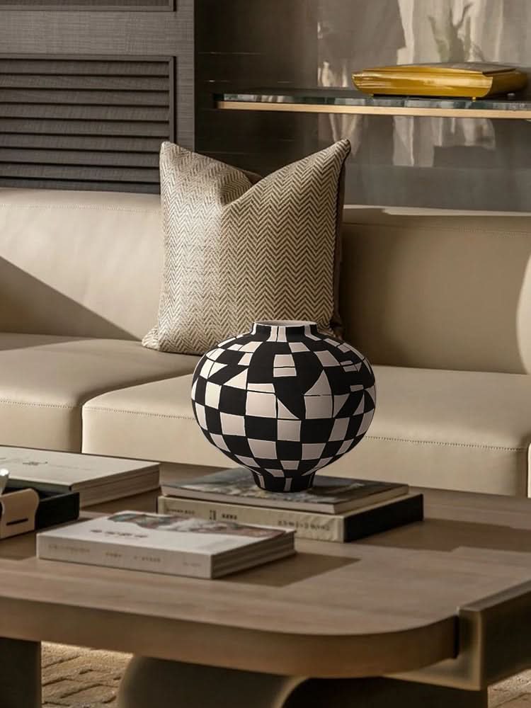 Black and white checkered ceramic vase on a coffee table with books, home decor